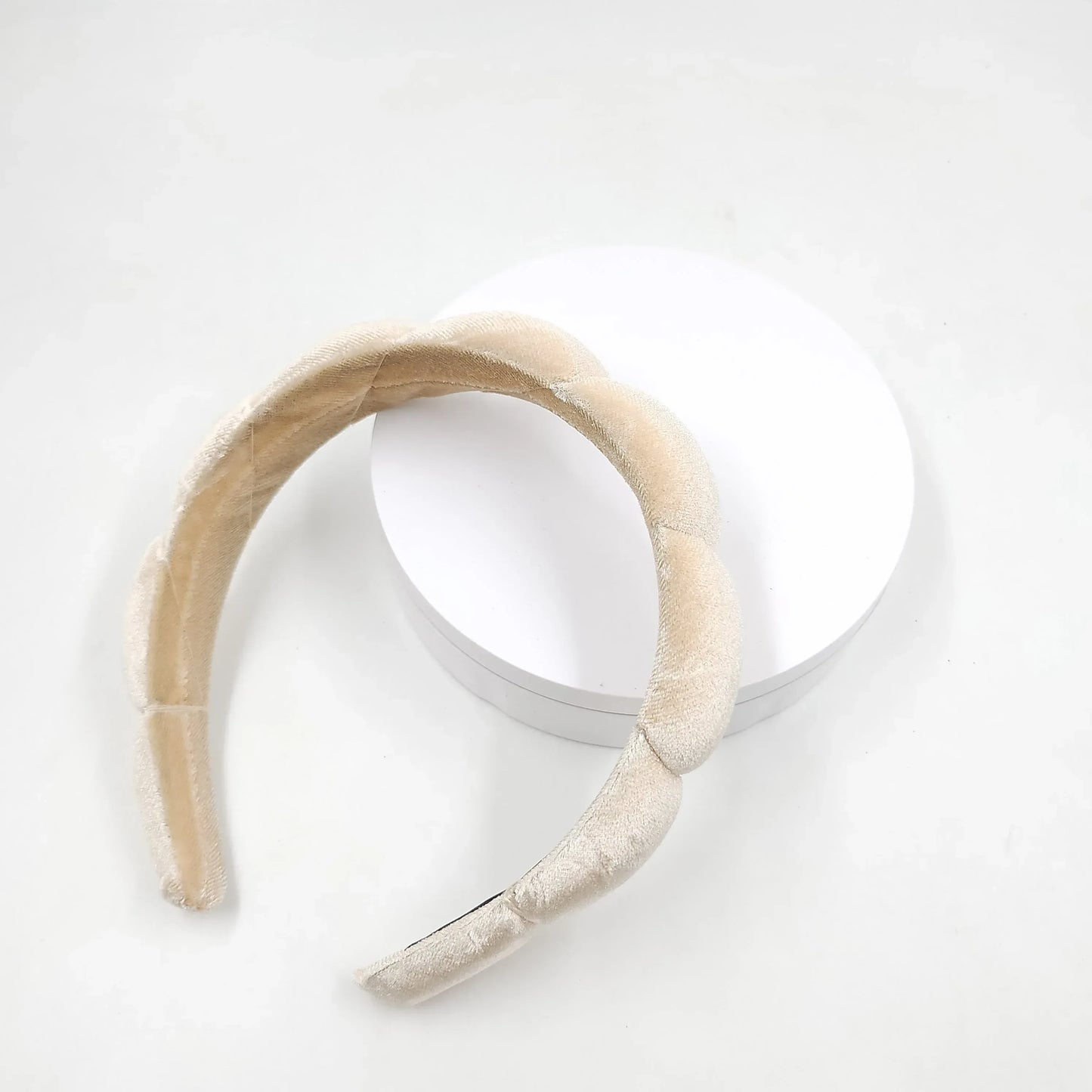 Beige headband on a white background