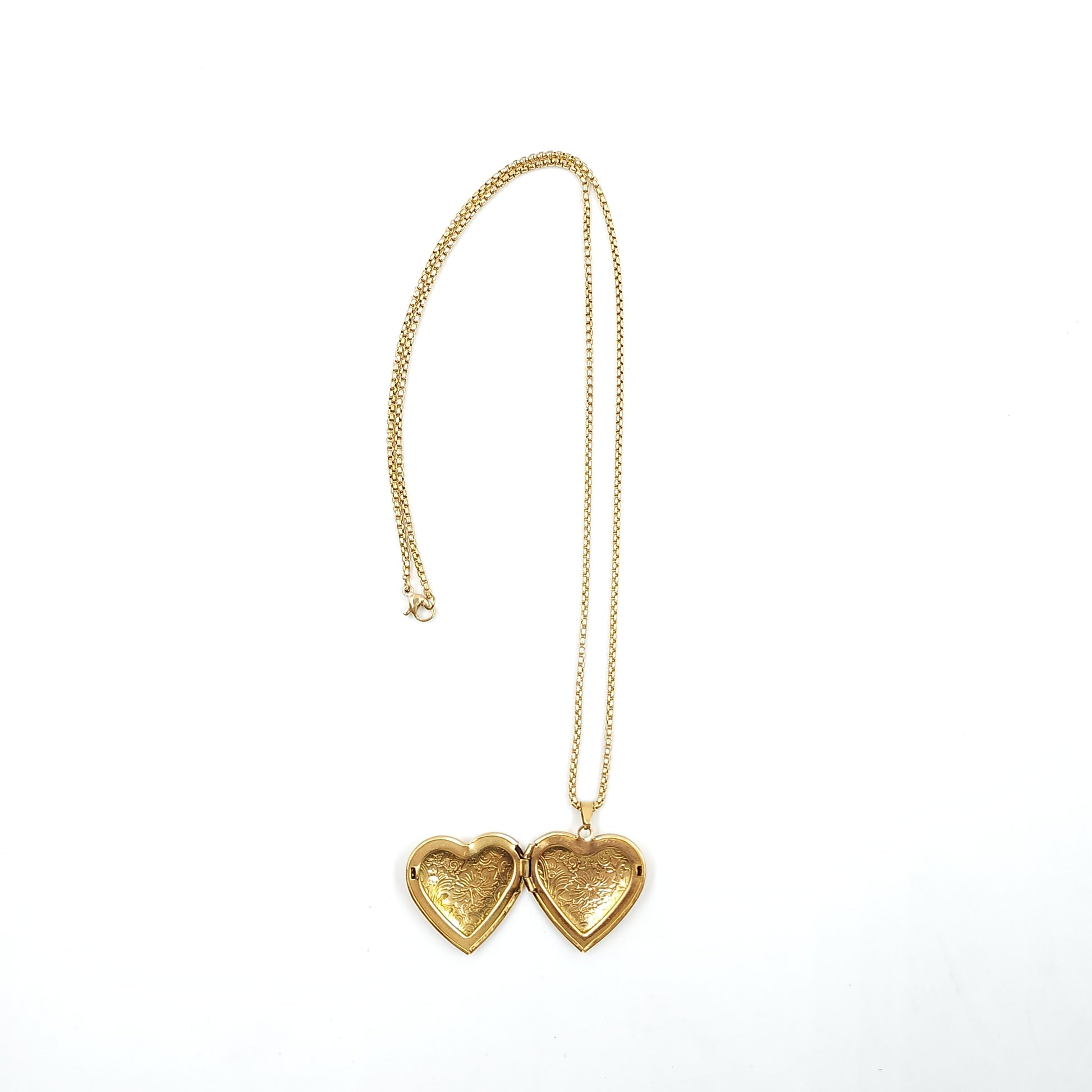 Gold heart-shaped necklace on a white background