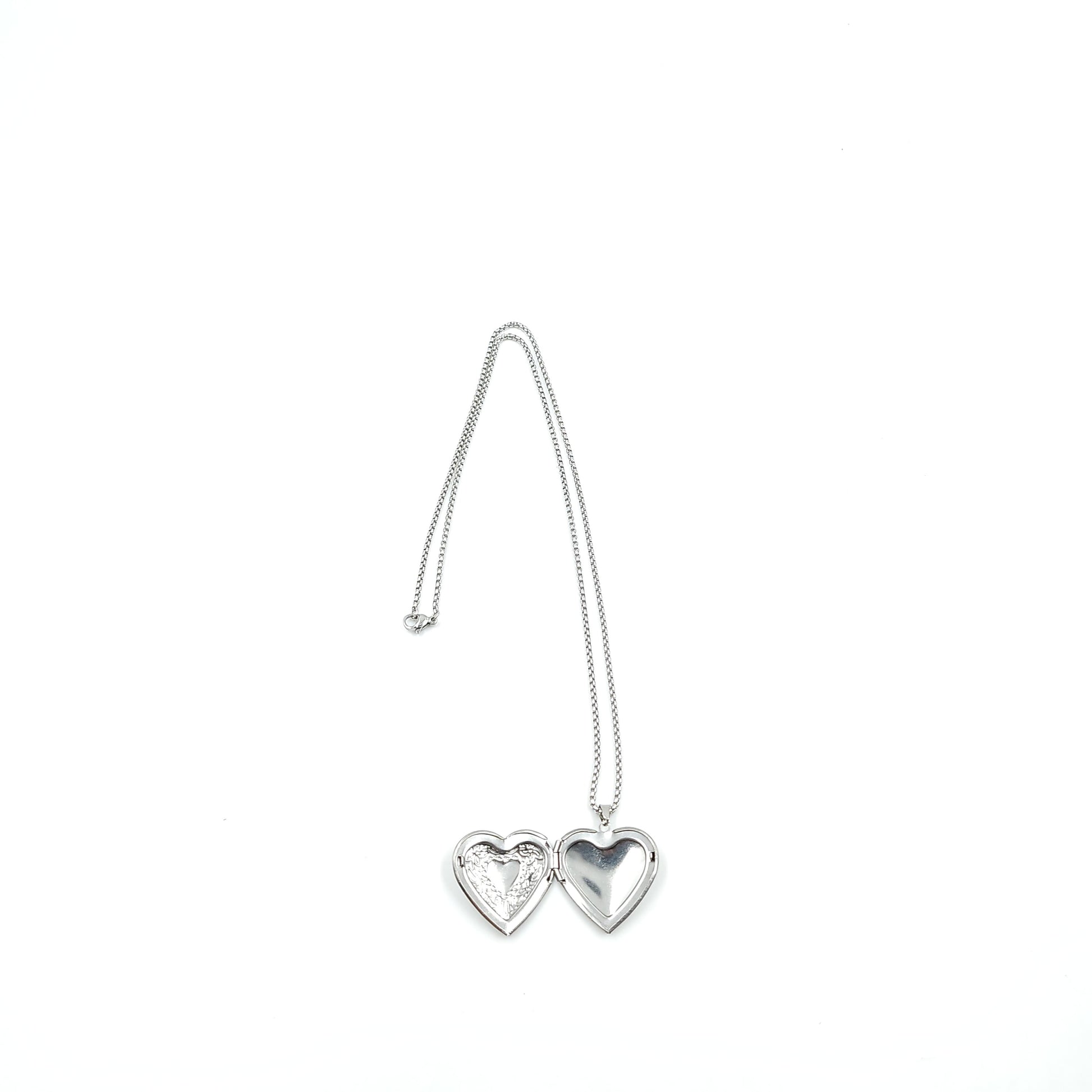 Silver necklace with a heart-shaped pendant on a white background