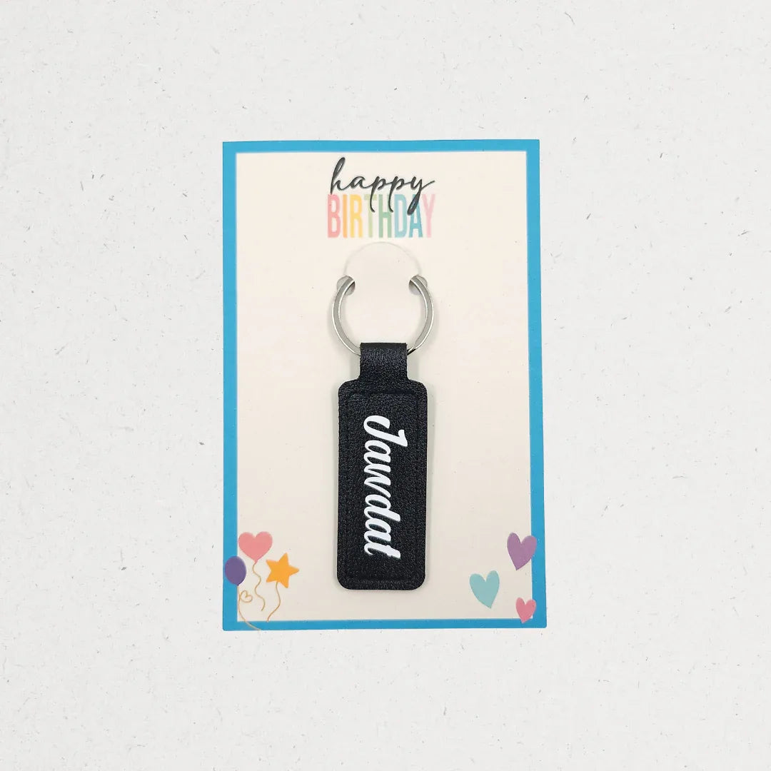 Black keychain with 'Jandal' text on a 'Happy Birthday' card with colorful text and icons. Customized gifts for all occasions Amman Jordan