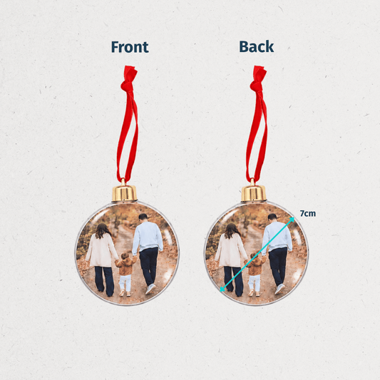 Personalized Christmas photo ornaments featuring a family photo in round and snowflake-shaped clear decorations with red hanging ribbons.
