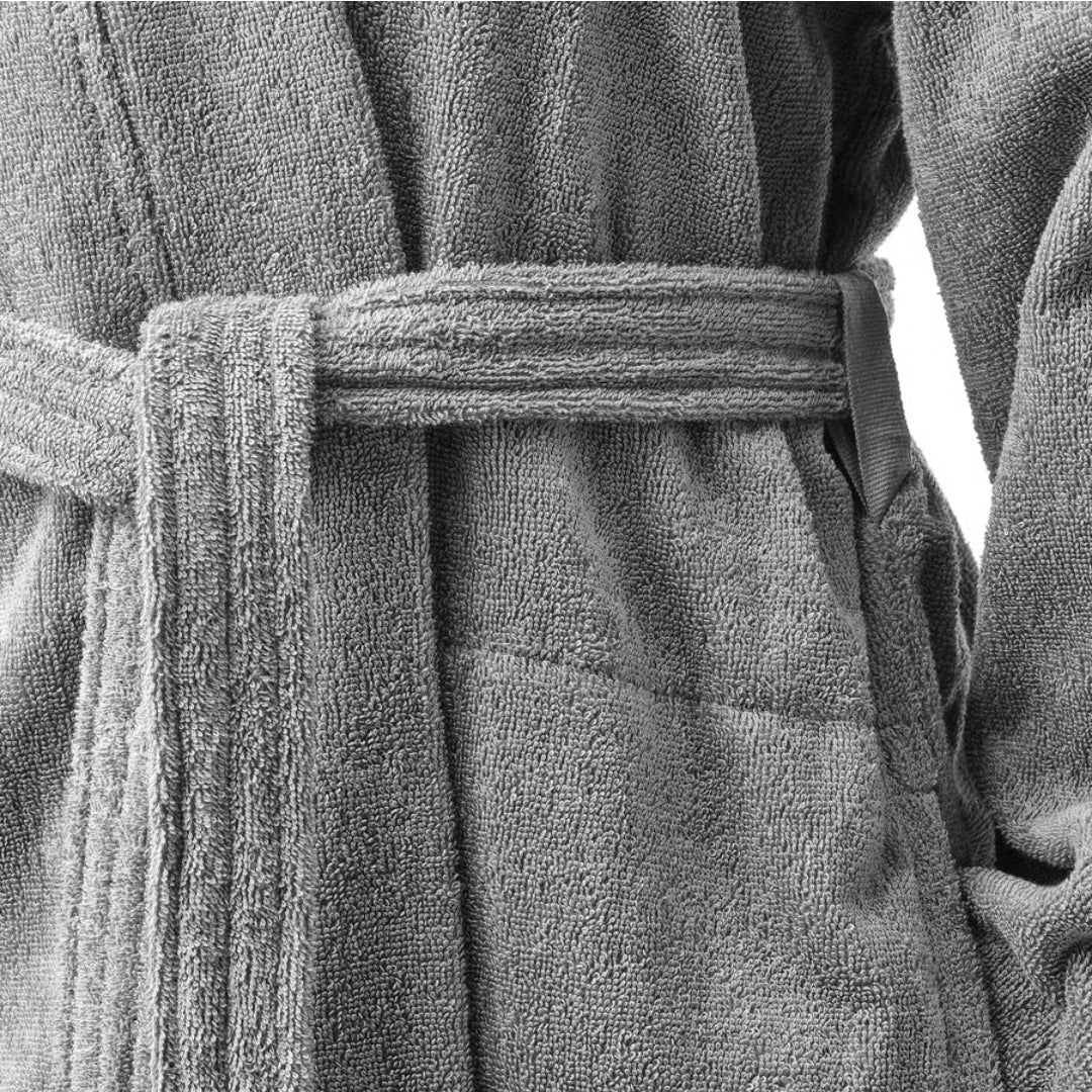 Close-up of a textured gray bathrobe with a belt.
