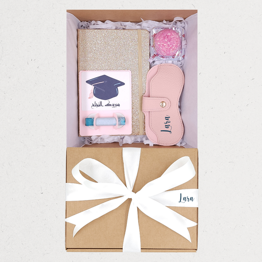 Gift set with notebook, sleep mask, and ball in a box with a bow